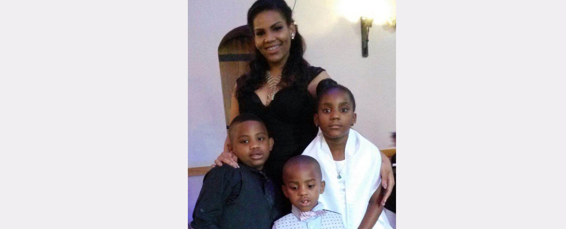A woman with her three small children.
