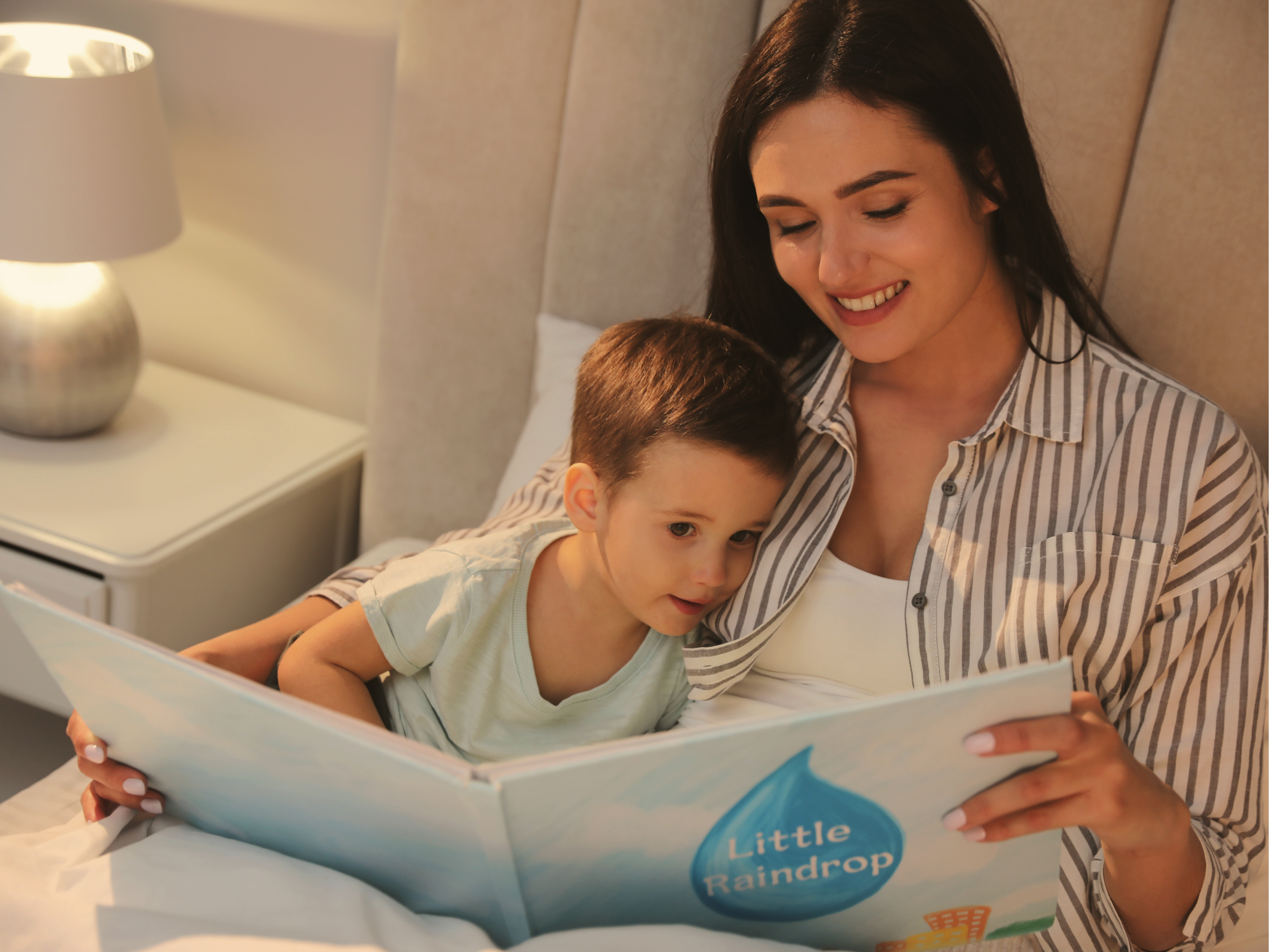 Mother and child reading a book in bed.