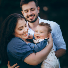 A woman and her child wash their hands at the kitchen sink.
